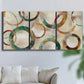 Three-panel canvas wall art featuring geometric circular abstract design, displayed in a living room above a sofa.
