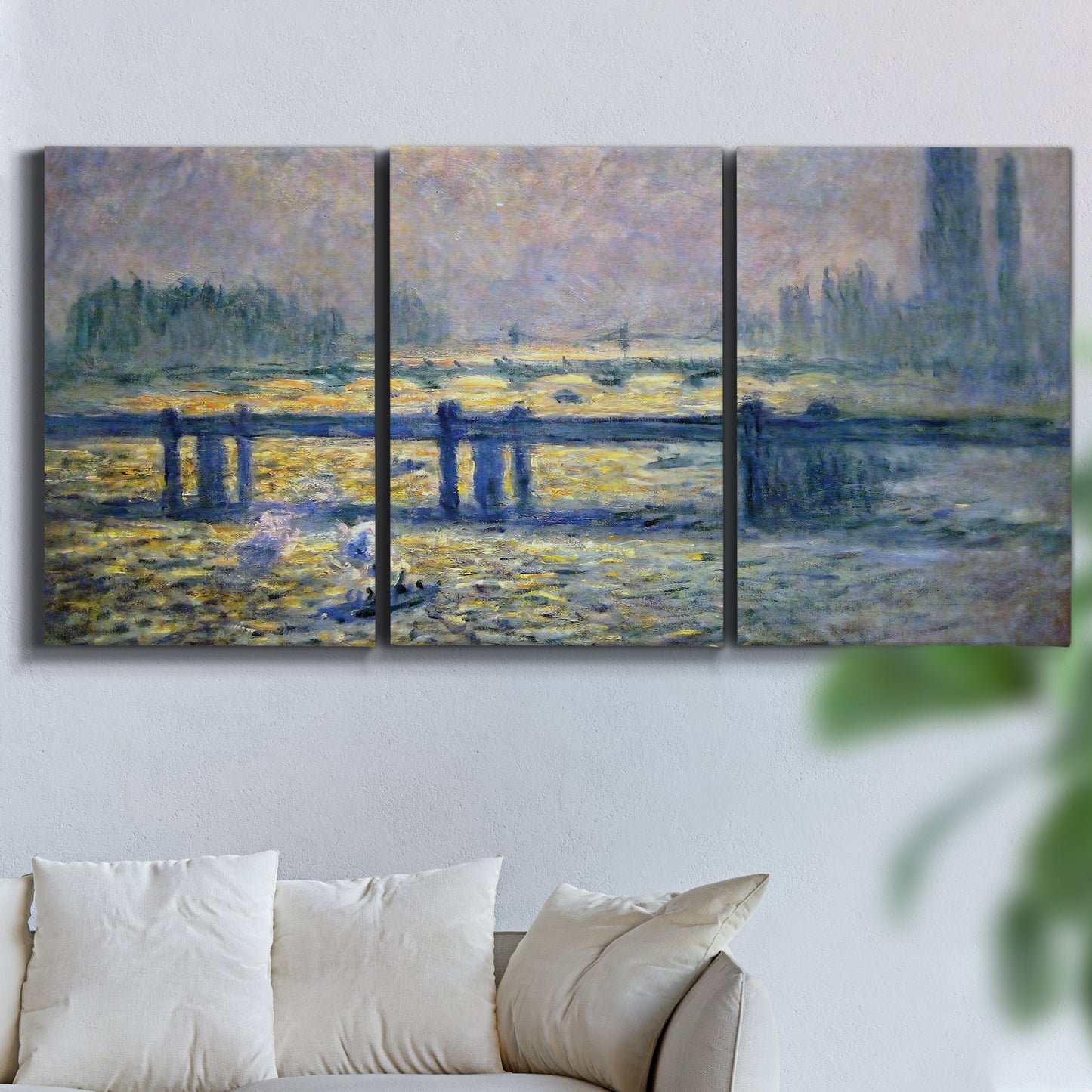 Three-panel canvas wall art featuring london bridge crossing wide river, displayed in a living room above a sofa.