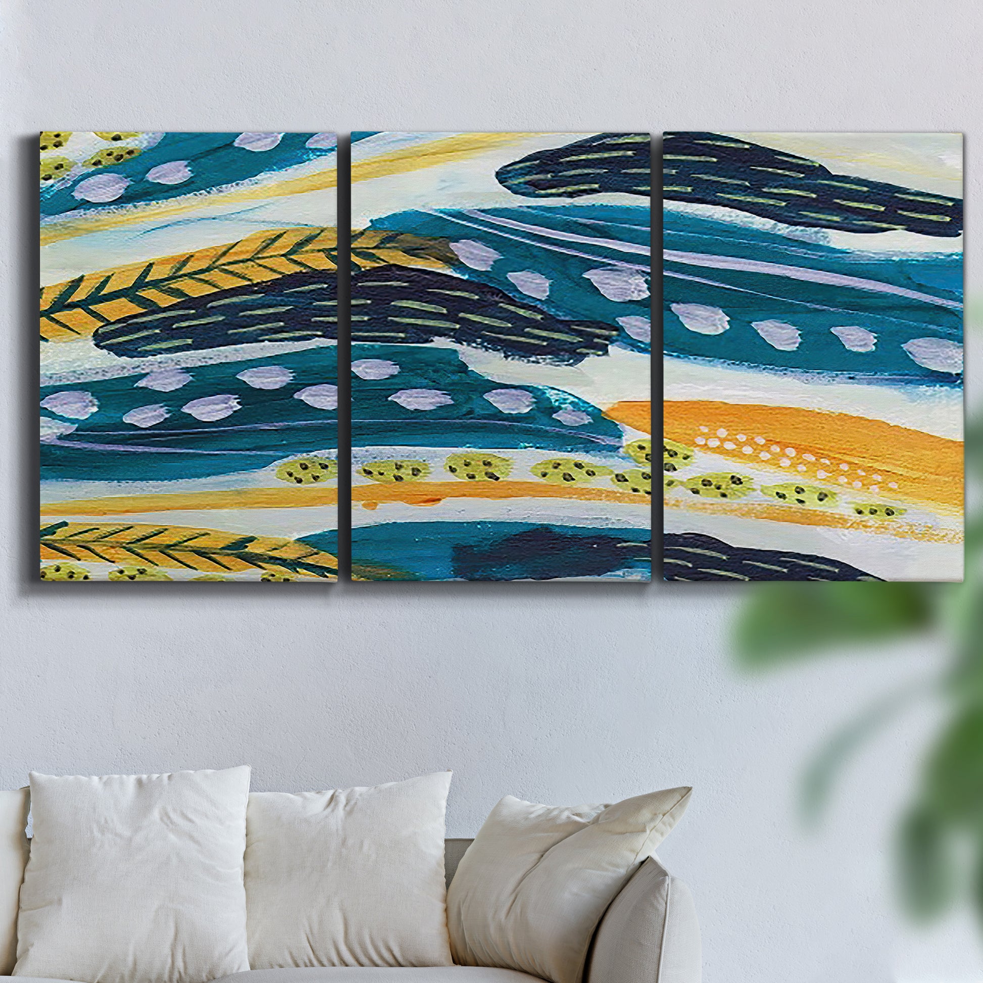 Three-panel canvas wall art featuring feather inspired abstract linear motion, displayed in a living room above a sofa.