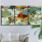 Three-panel canvas wall art featuring celebratory abstract color movement, displayed in a living room above a sofa.