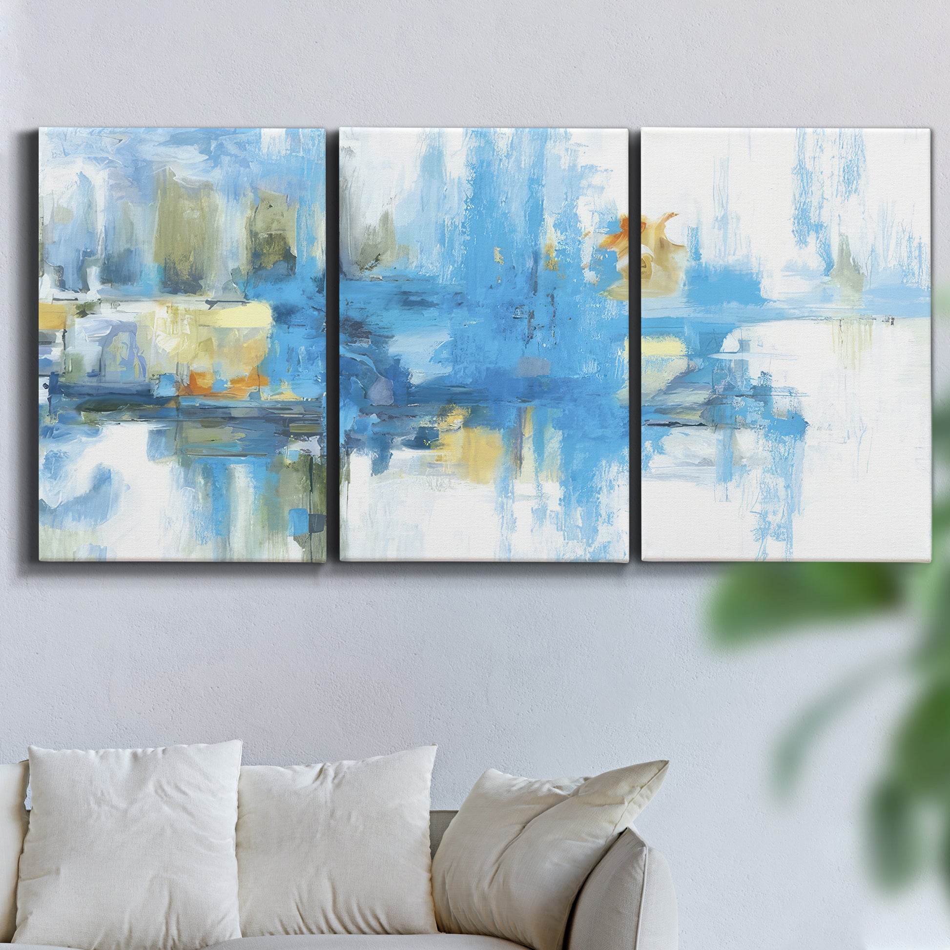Three-panel canvas wall art featuring blue toned abstract city rhythm, displayed in a living room above a sofa.