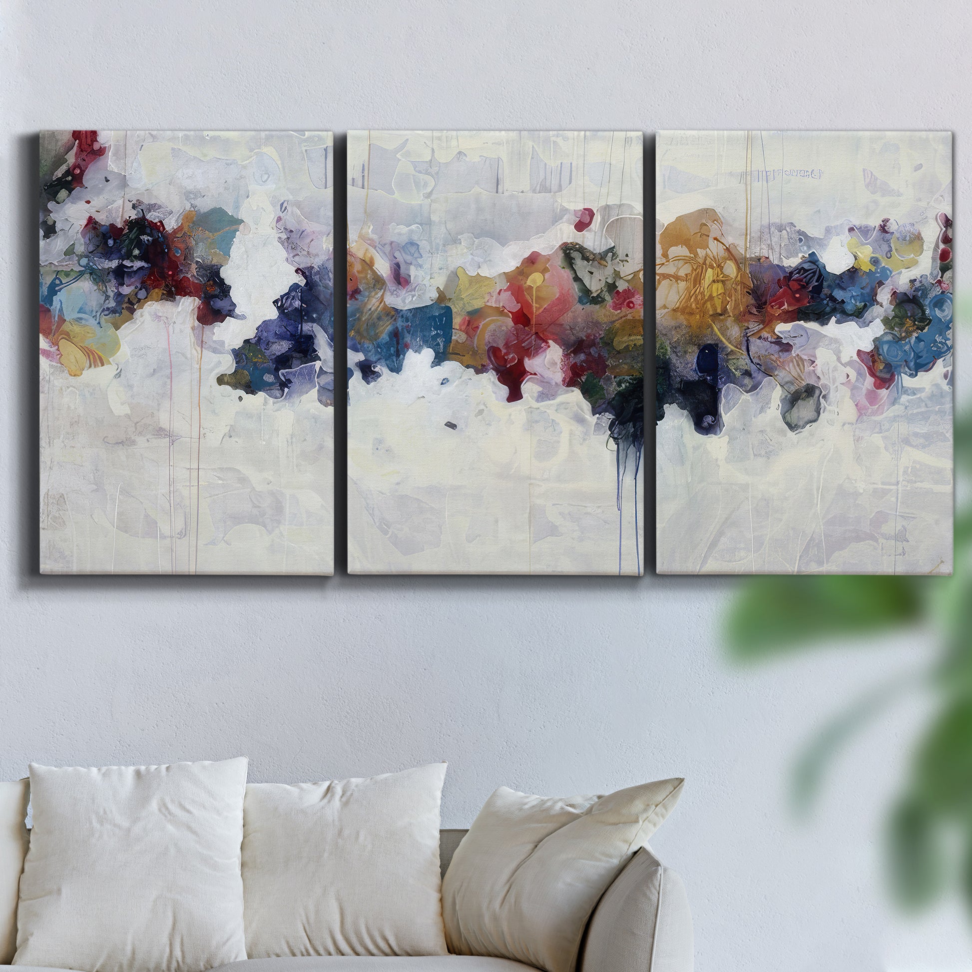 Three-panel canvas wall art featuring abstract water inspired composition, displayed in a living room above a sofa.