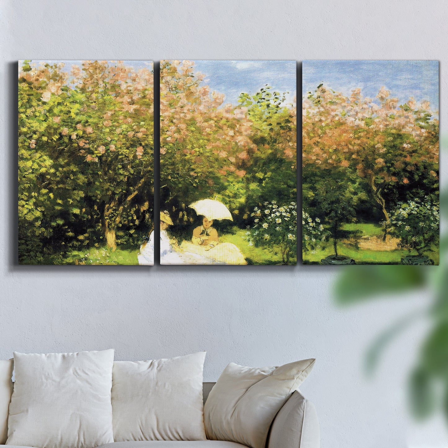 Three-panel canvas wall art featuring lush garden landscape with trees, displayed in a living room above a sofa.