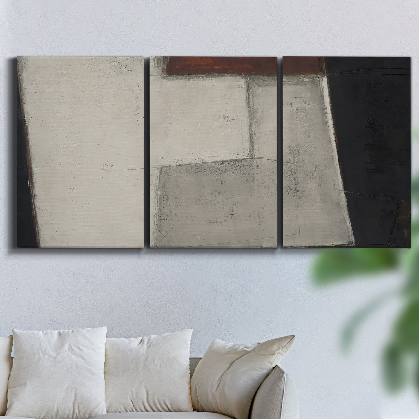 Three-panel canvas wall art featuring geometric abstract roadway motif, displayed in a living room above a sofa.