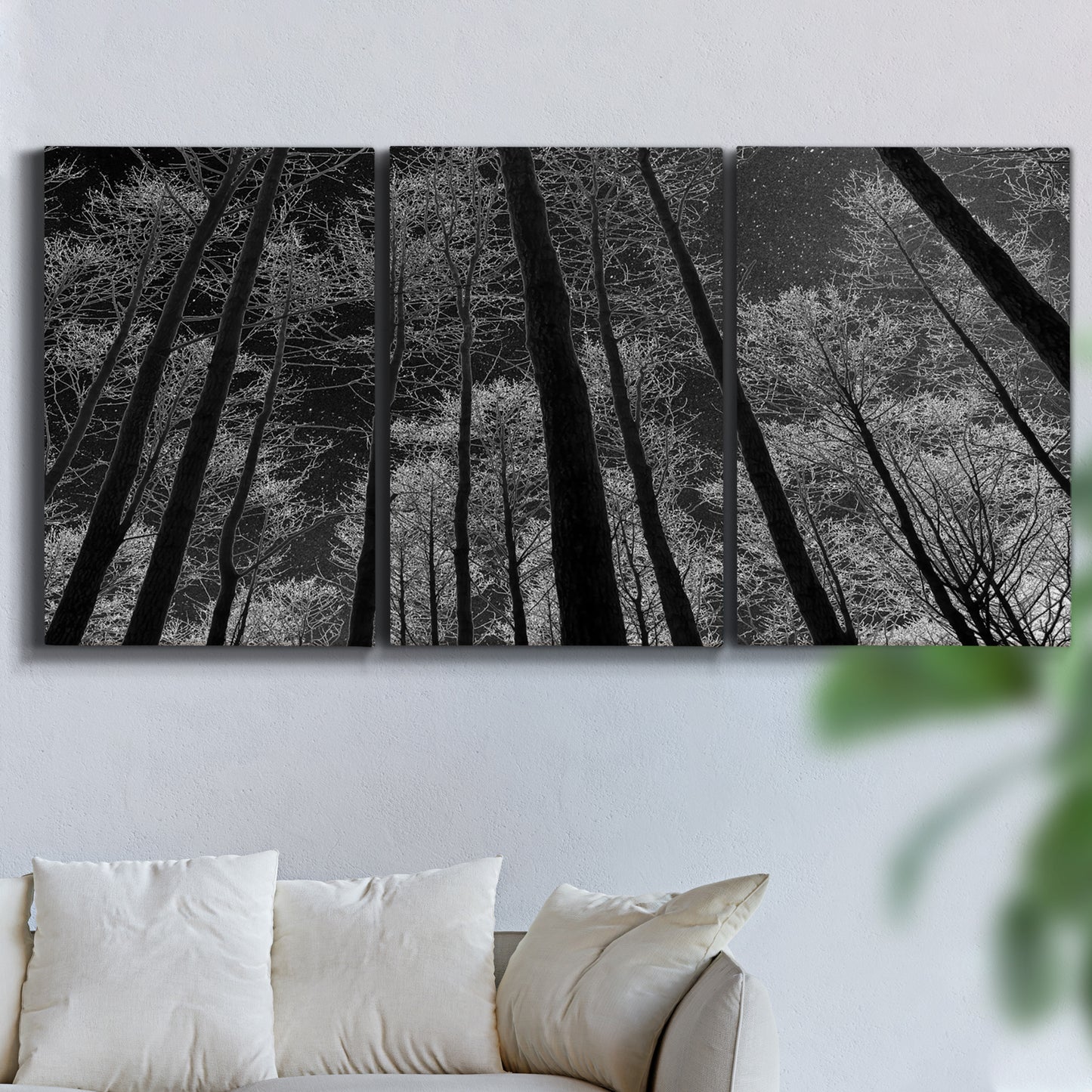 Three-panel canvas wall art featuring riverside houses along canal, displayed in a living room above a sofa.