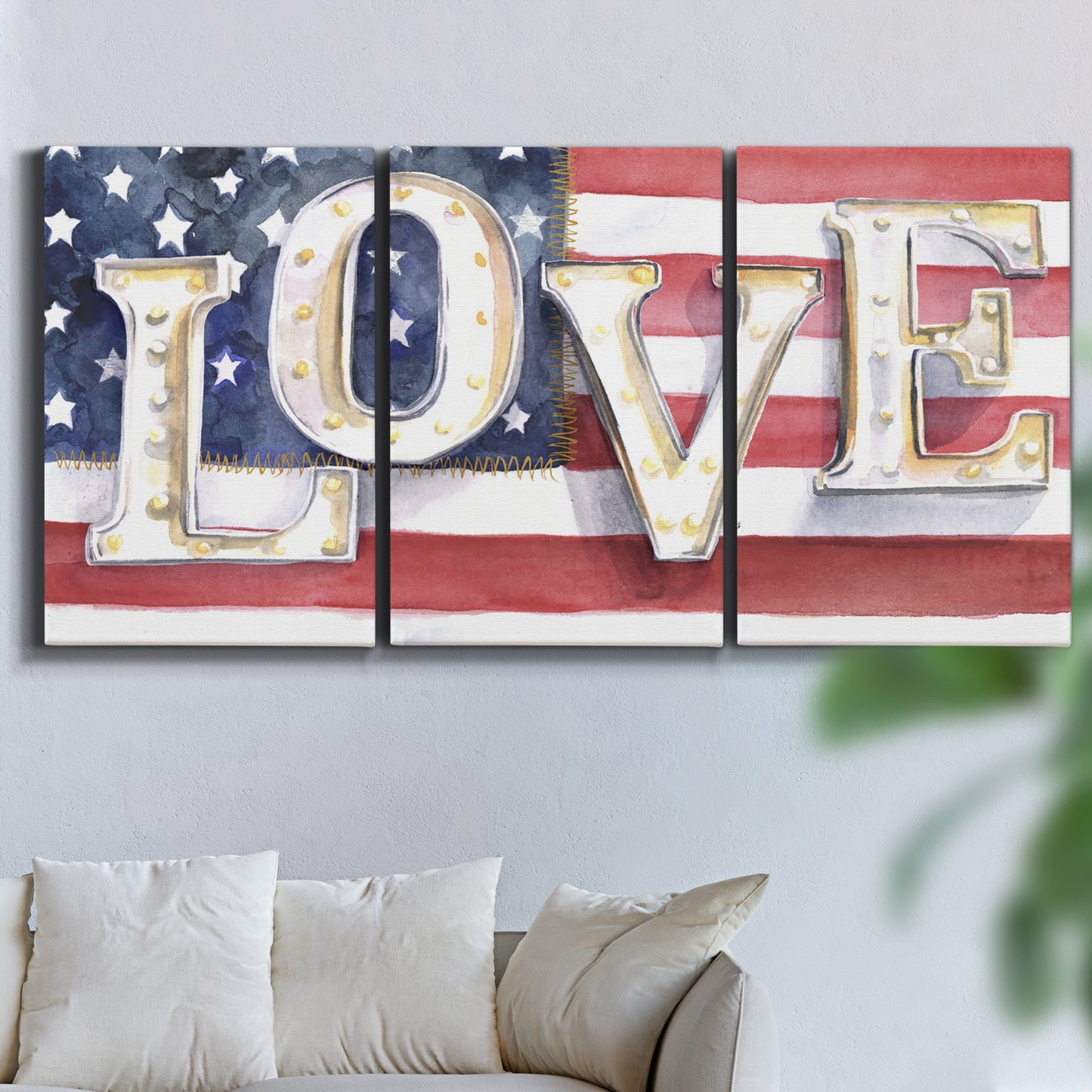 Three-panel canvas wall art featuring patriotic rustic typography art, displayed in a living room above a sofa.