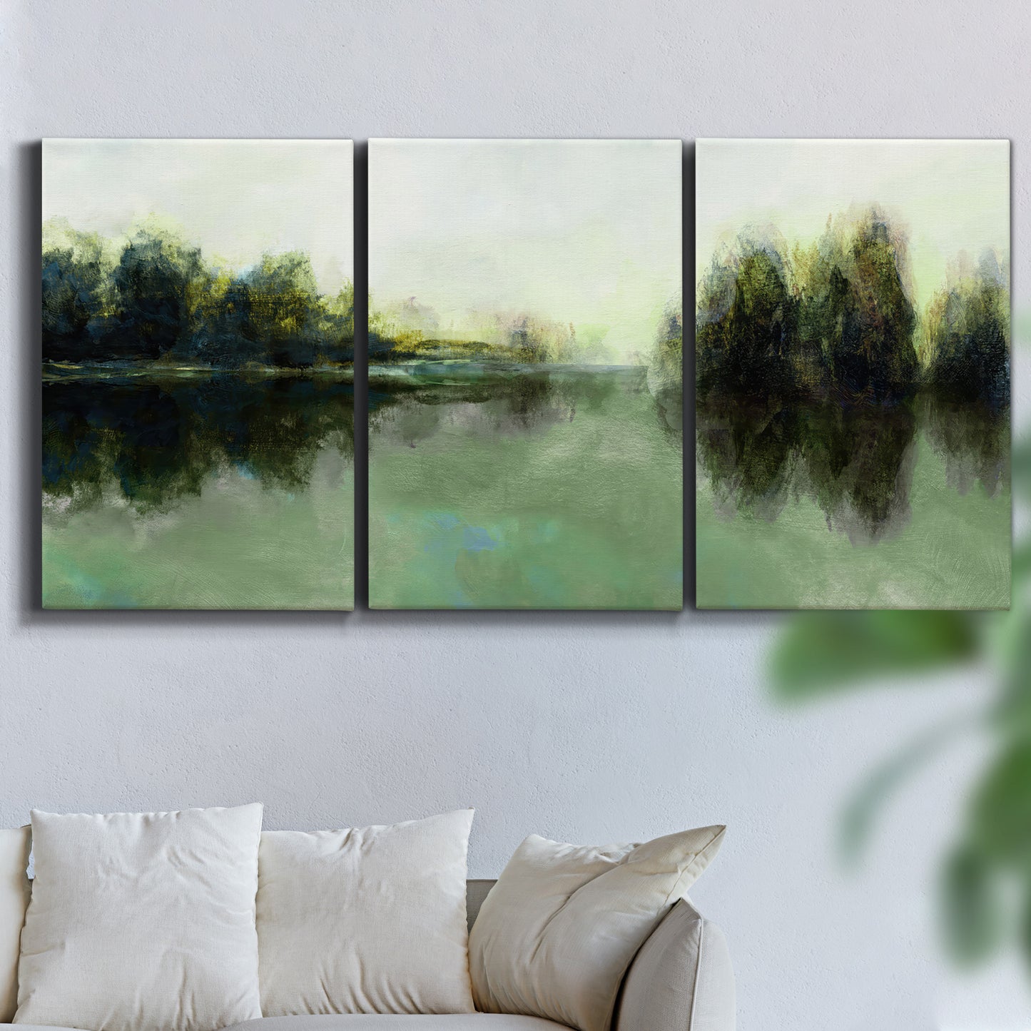 Three-panel canvas wall art featuring rain soaked landscape at sunset, displayed in a living room above a sofa.
