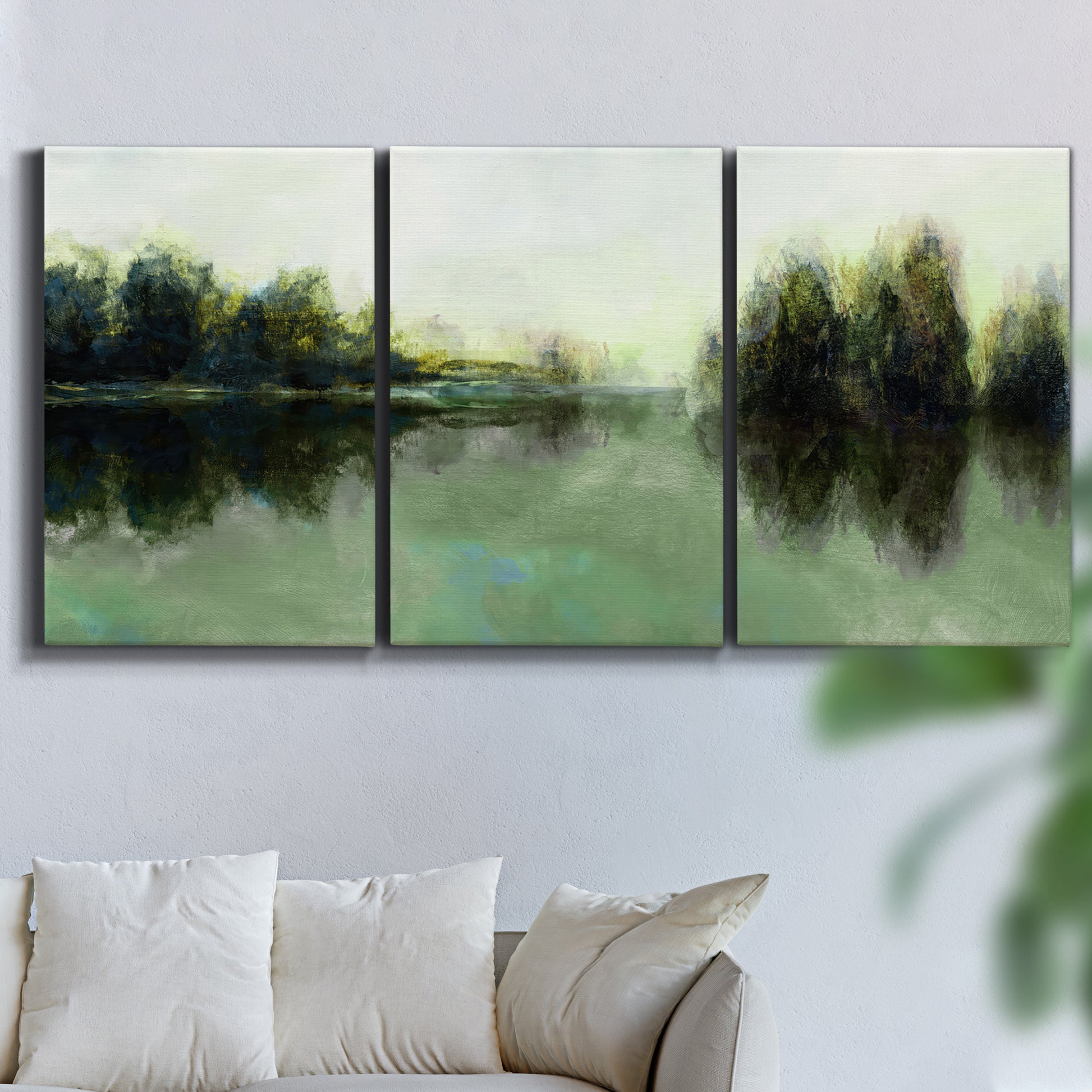 Three-panel canvas wall art featuring rain soaked landscape at sunset, displayed in a living room above a sofa.