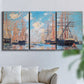 Three-panel canvas wall art featuring harbor with boats and water, displayed in a living room above a sofa.