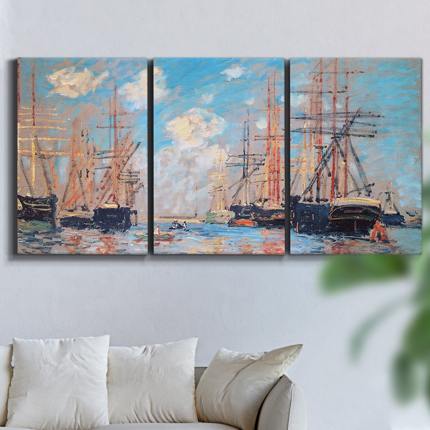 Three-panel canvas wall art featuring harbor with boats and water, displayed in a living room above a sofa.