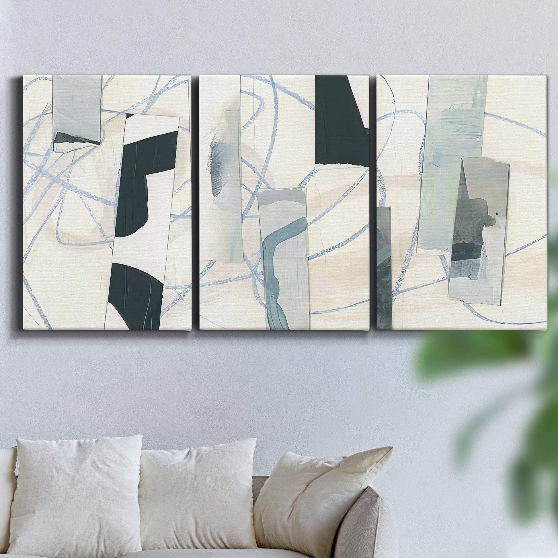 Three-panel canvas wall art featuring interwoven icy abstract linear forms, displayed in a living room above a sofa.
