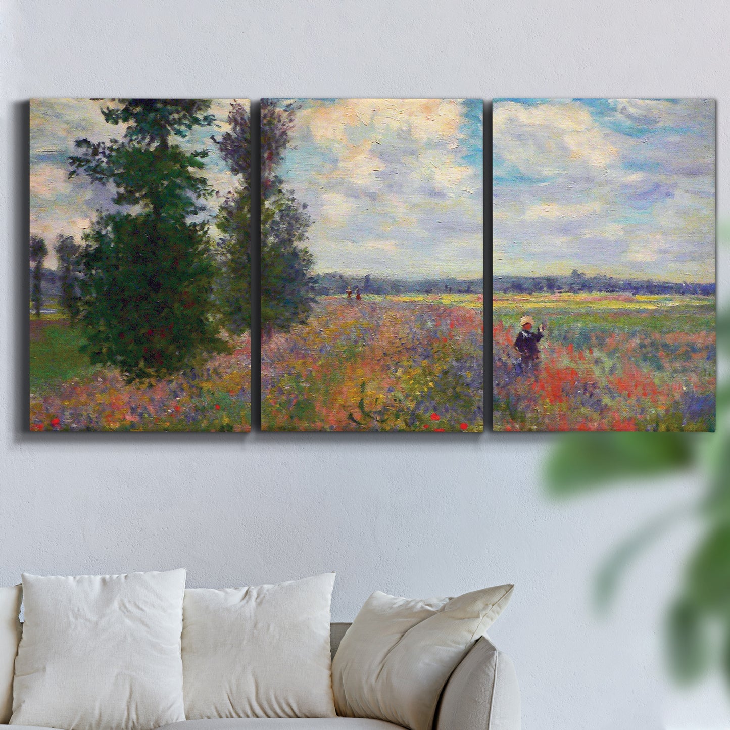 Three-panel canvas wall art featuring poppy field in open countryside, displayed in a living room above a sofa.