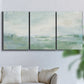 Three-panel canvas wall art featuring soft abstract coastal tones, displayed in a living room above a sofa.
