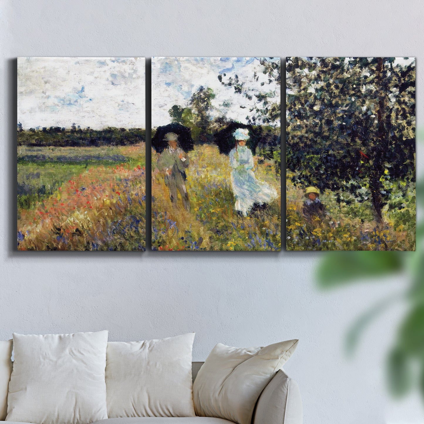 Three-panel canvas wall art featuring figures walking along riverbank, displayed in a living room above a sofa.