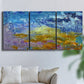 Three-panel canvas wall art featuring expressive abstract with layered color, displayed in a living room above a sofa.