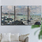 Three-panel canvas wall art featuring rough seas along rocky coast, displayed in a living room above a sofa.