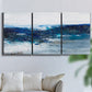 Three-panel canvas wall art featuring moody abstract sea with depth, displayed in a living room above a sofa.