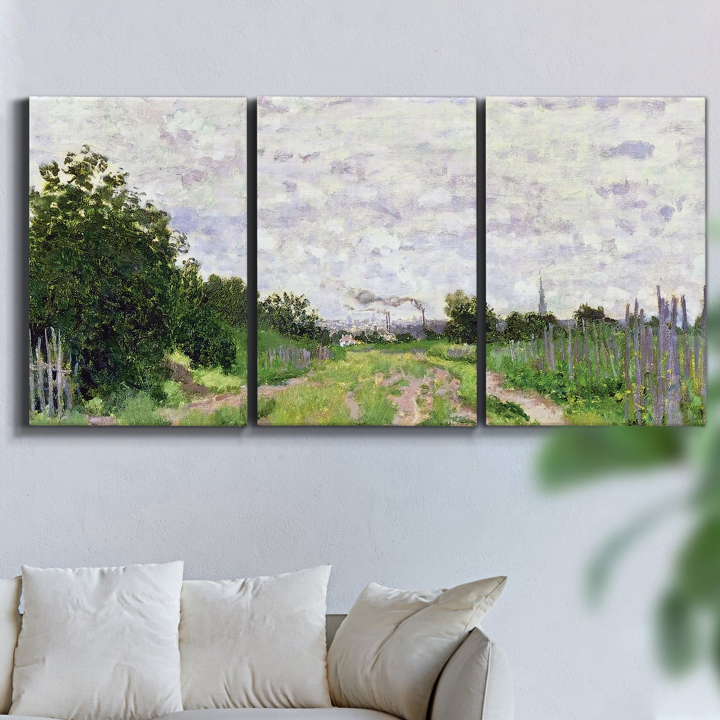 Three-panel canvas wall art featuring spring landscape with blossoming trees, displayed in a living room above a sofa.