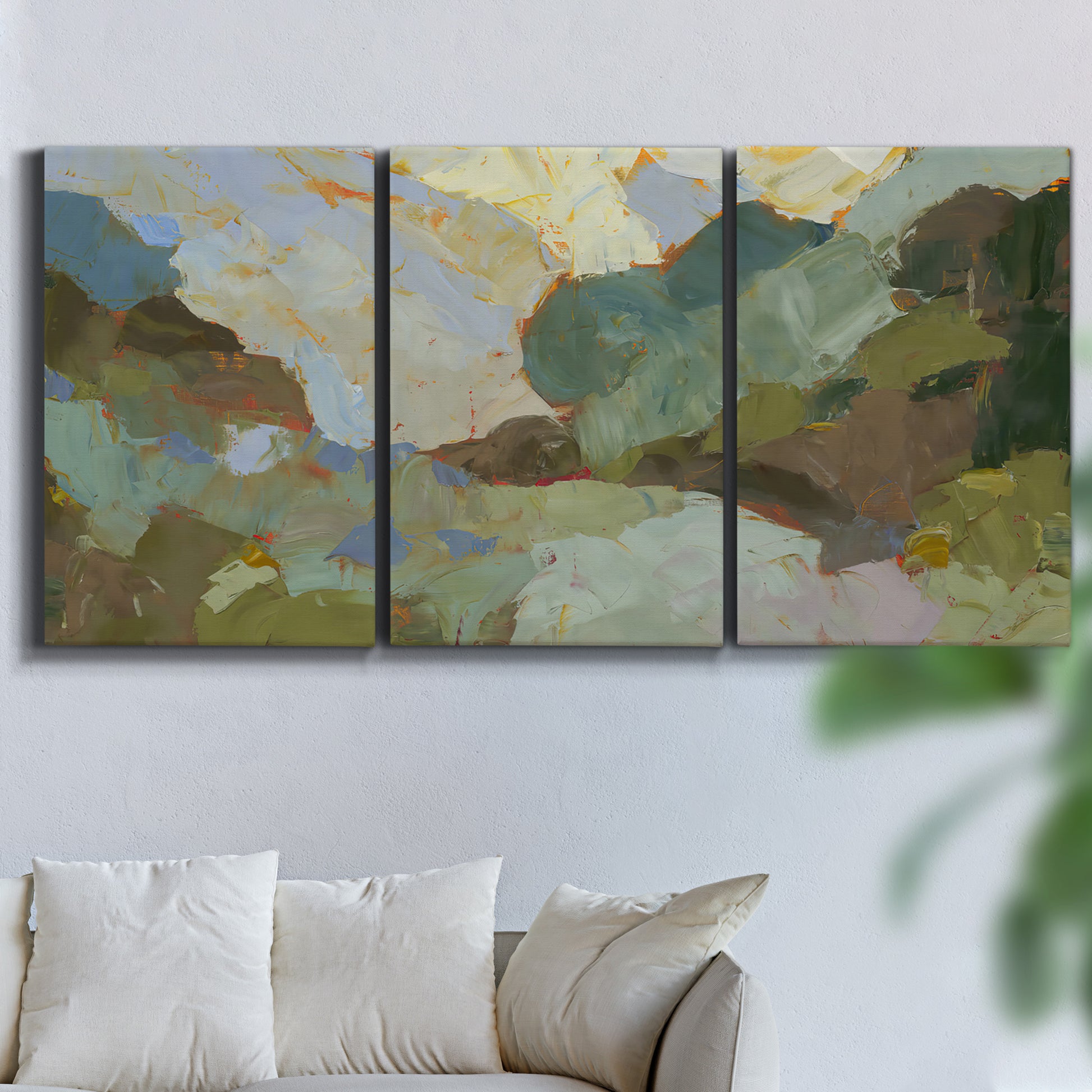 Three-panel canvas wall art featuring abstract landscape suggesting travel pause, displayed in a living room above a sofa.