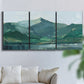 Three-panel canvas wall art featuring muted mountain range in grey tones, displayed in a living room above a sofa.