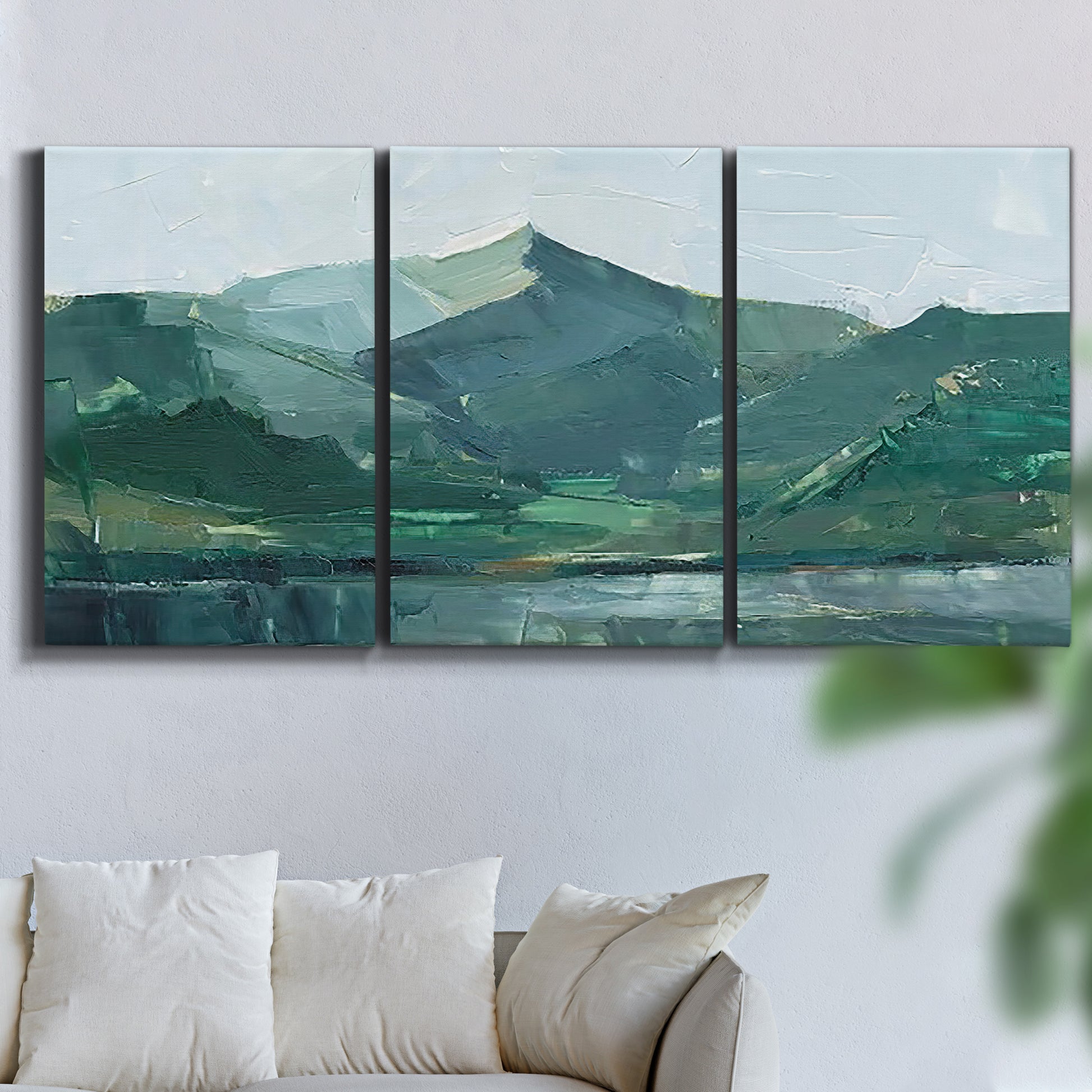 Three-panel canvas wall art featuring muted mountain range in grey tones, displayed in a living room above a sofa.