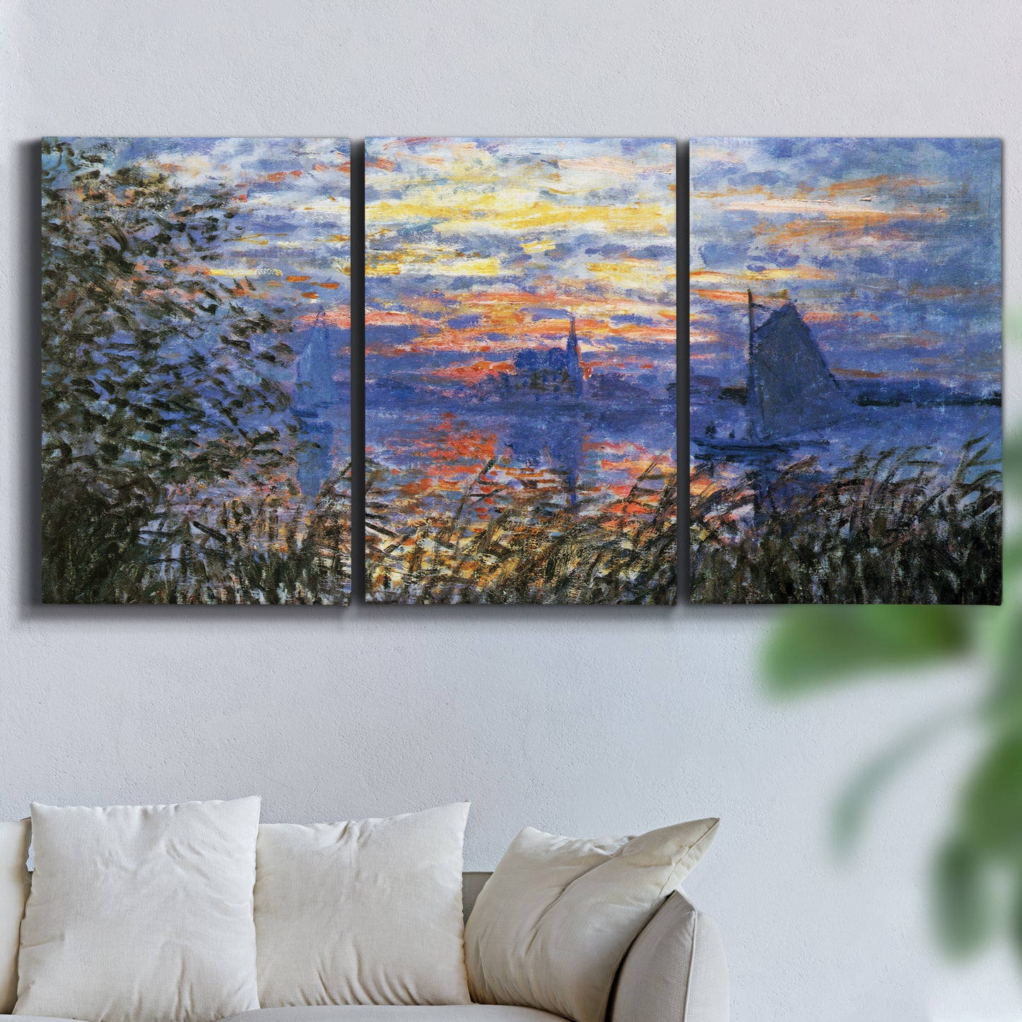 Three-panel canvas wall art featuring river sunset with reflections, displayed in a living room above a sofa.