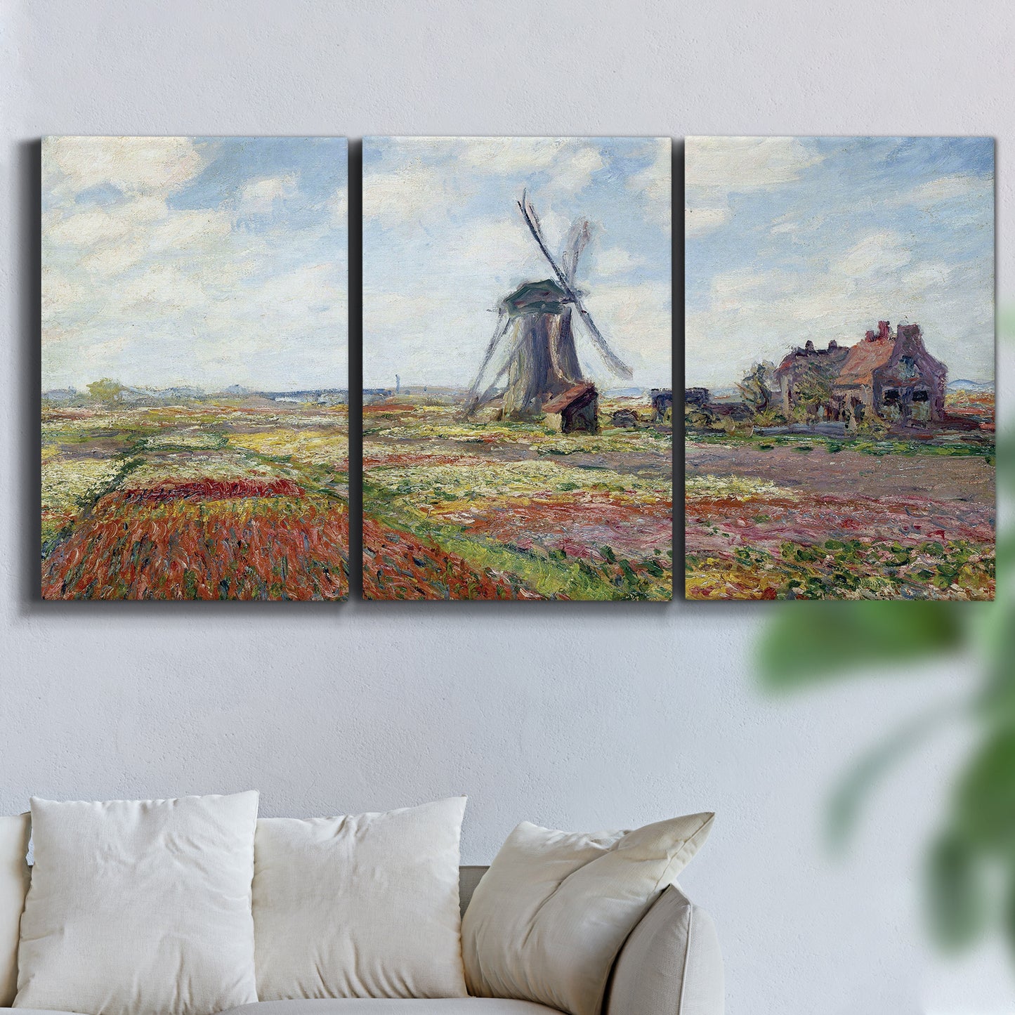 Three-panel canvas wall art featuring tulip fields with windmill, displayed in a living room above a sofa.