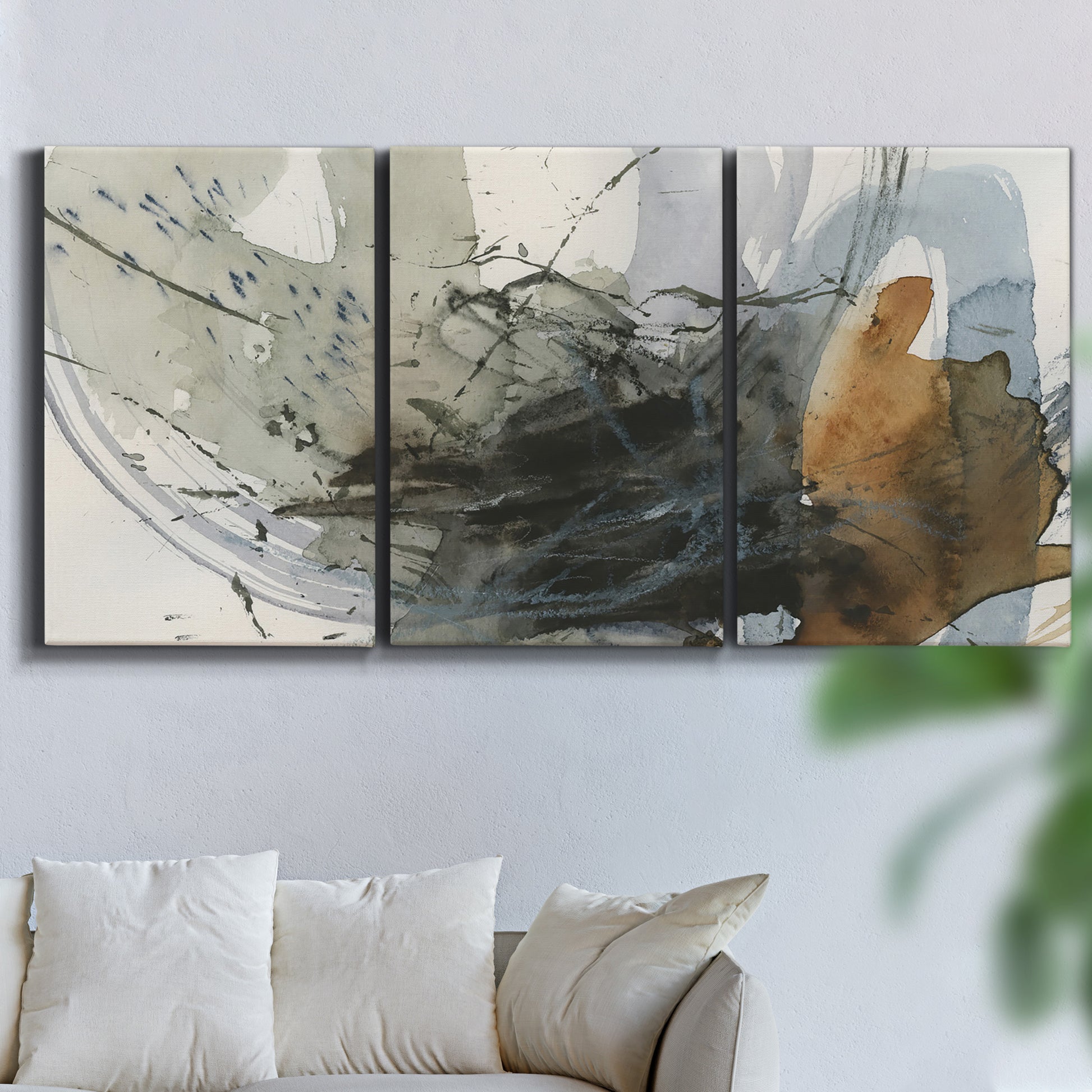 Three-panel canvas wall art featuring dynamic circular abstract motion, displayed in a living room above a sofa.