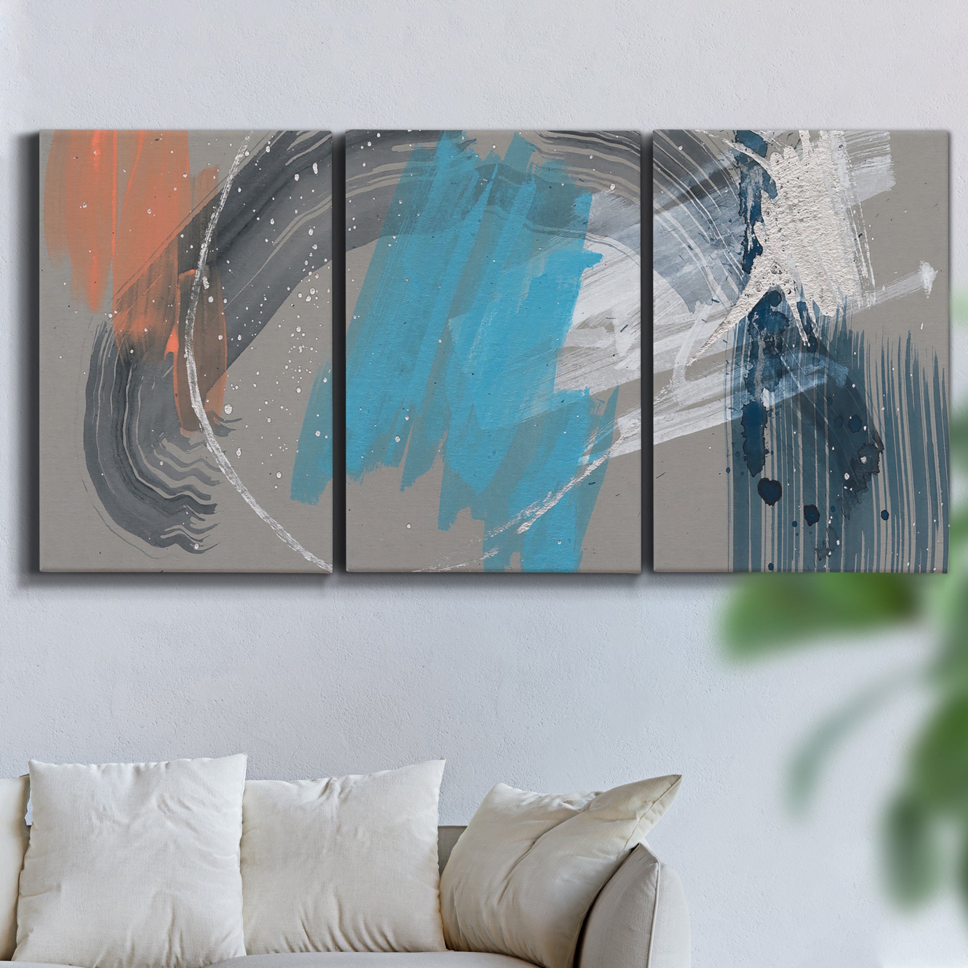Three-panel canvas wall art featuring playful abstract mark making, displayed in a living room above a sofa.