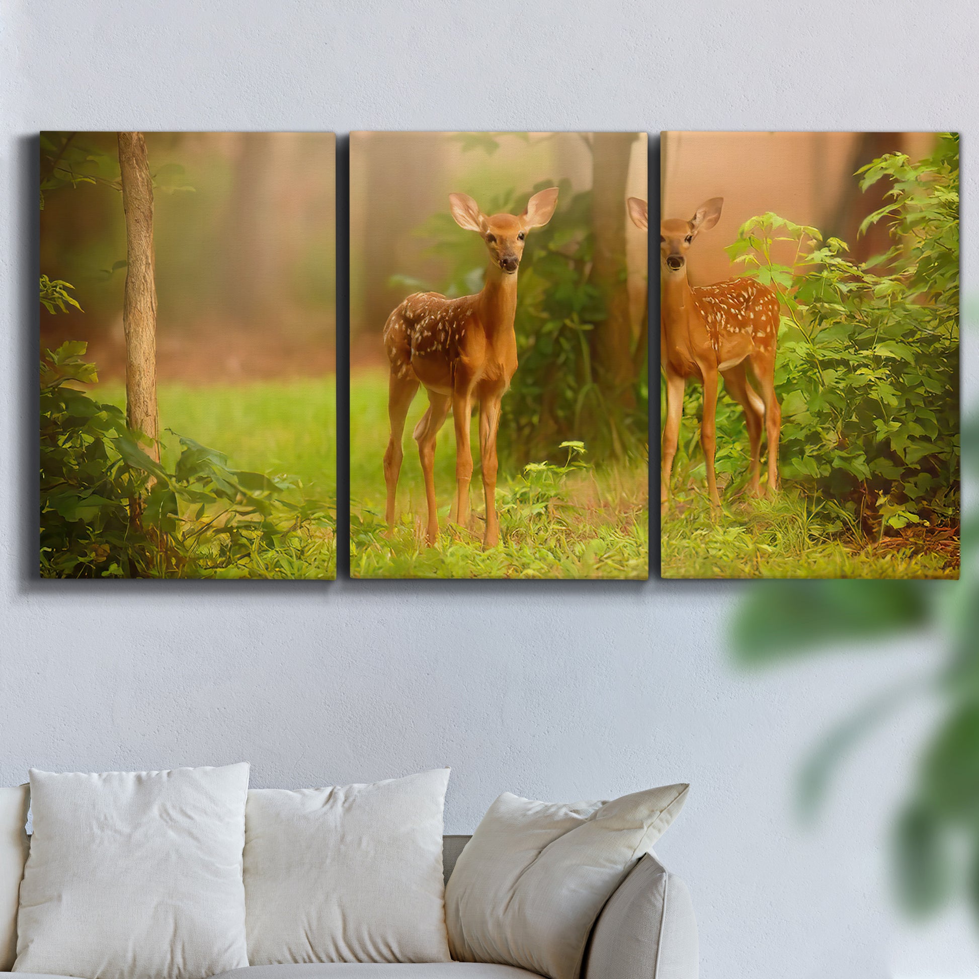 Three-panel canvas wall art featuring resting animals in open field, displayed in a living room above a sofa.