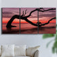 Three-panel canvas wall art featuring sunset beach photography, displayed in a living room above a sofa.