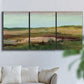 Three-panel canvas wall art featuring pastoral landscape with winding road, displayed in a living room above a sofa.