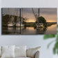 Three-panel canvas wall art featuring fishing trawlers on working harbor, displayed in a living room above a sofa.