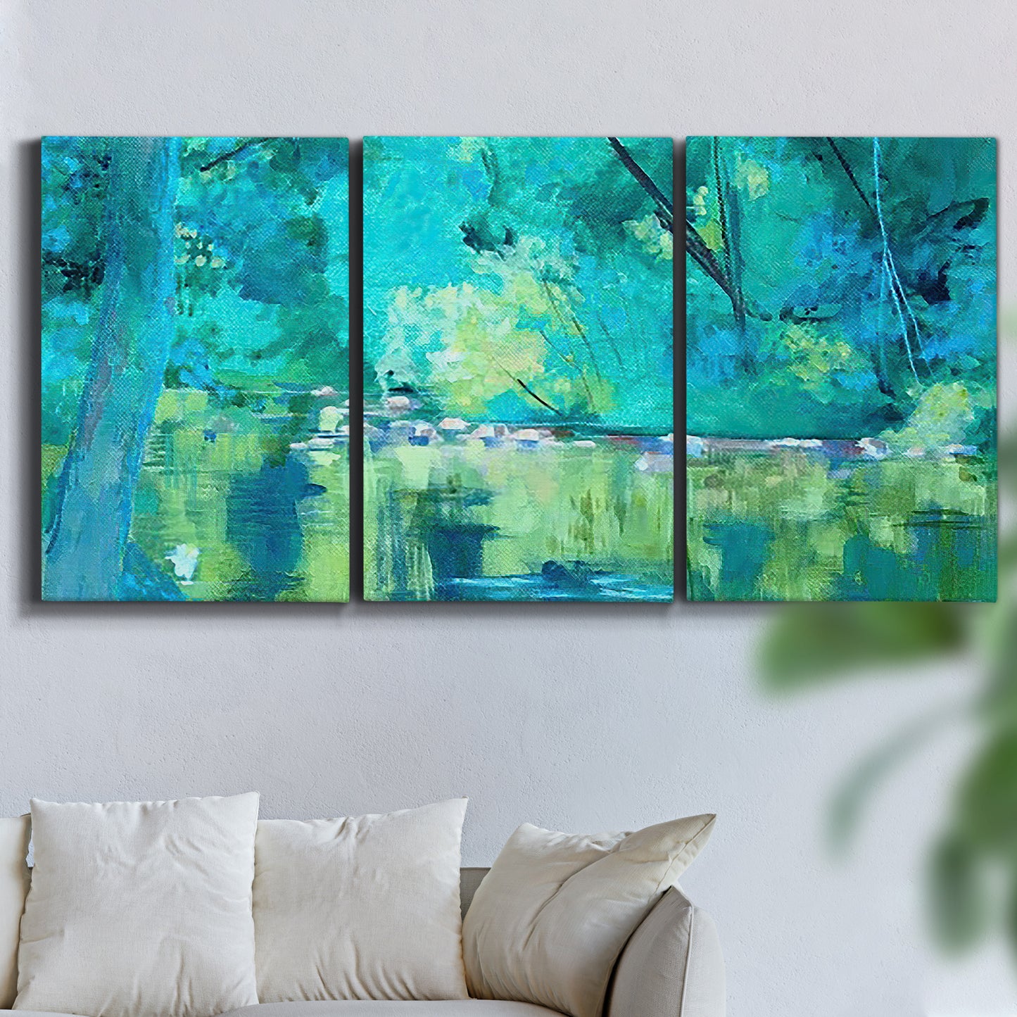 Three-panel canvas wall art featuring abstract river composition with movement, displayed in a living room above a sofa.
