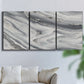 Three-panel canvas wall art featuring minimal monochrome abstract forms, displayed in a living room above a sofa.
