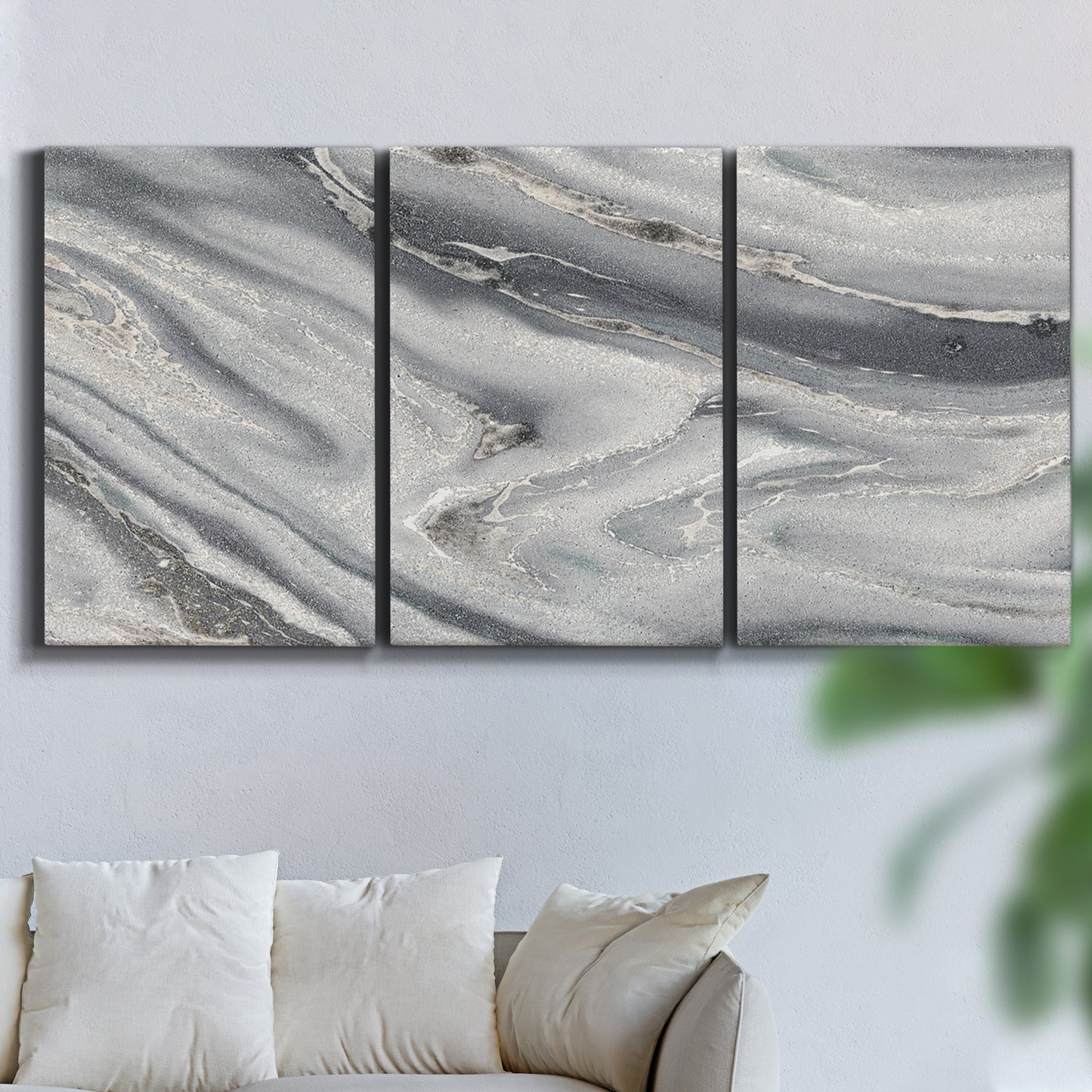 Three-panel canvas wall art featuring minimal monochrome abstract forms, displayed in a living room above a sofa.