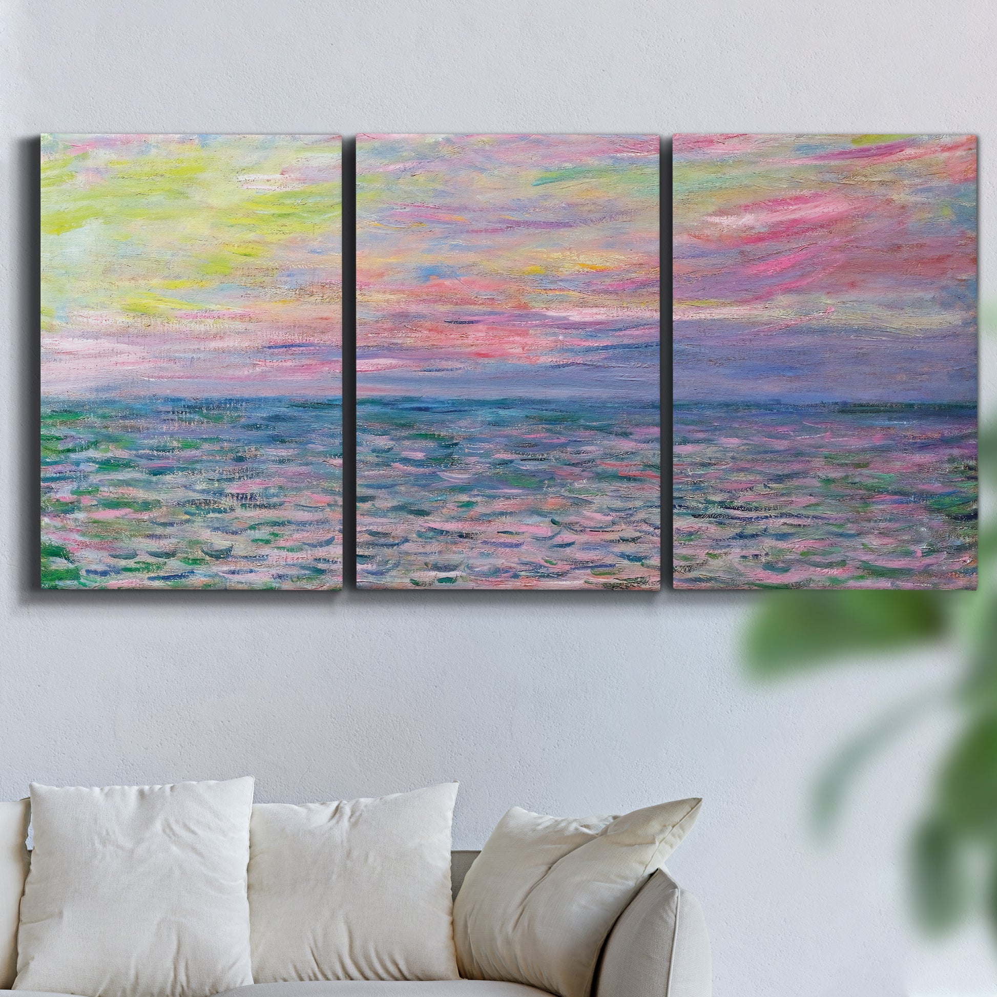Three-panel canvas wall art featuring sunset reflections across calm sea, displayed in a living room above a sofa.
