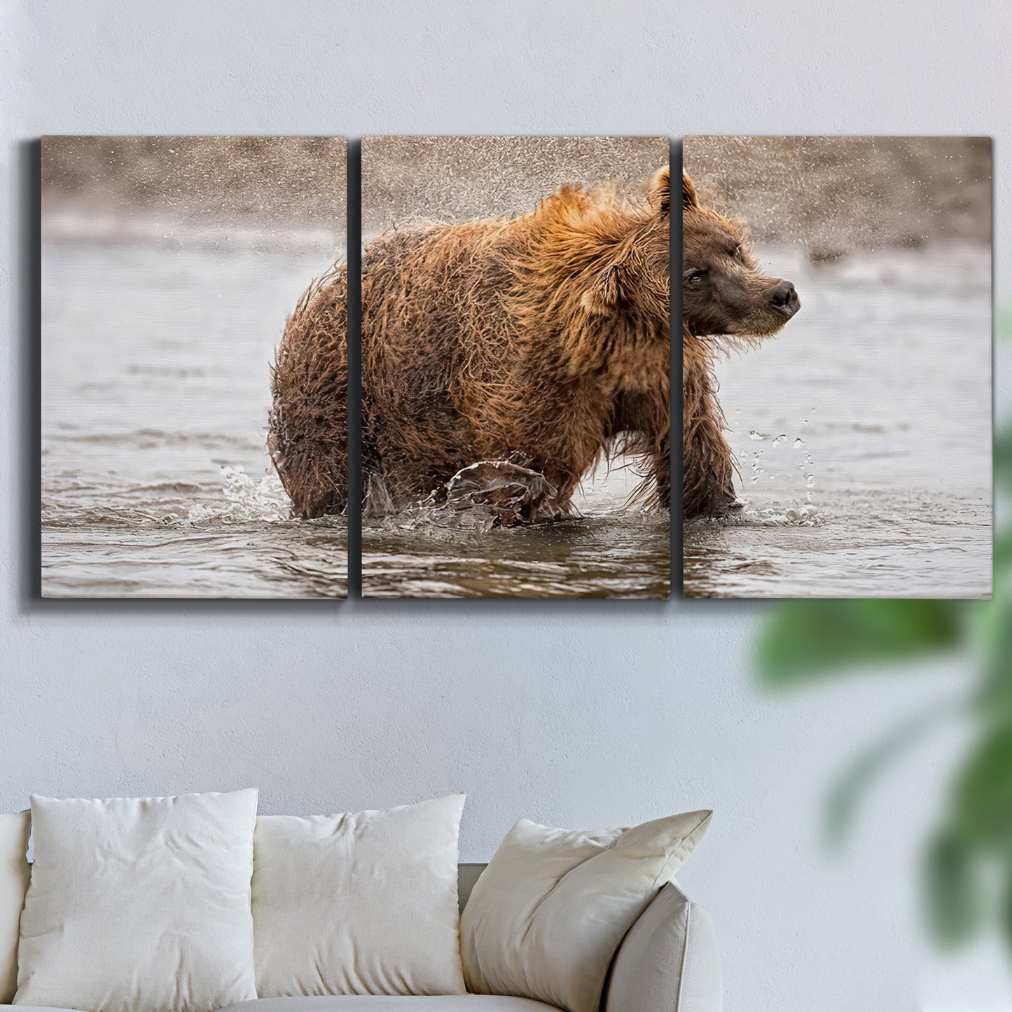 Three-panel canvas wall art featuring wildlife photography animal portrait, displayed in a living room above a sofa.