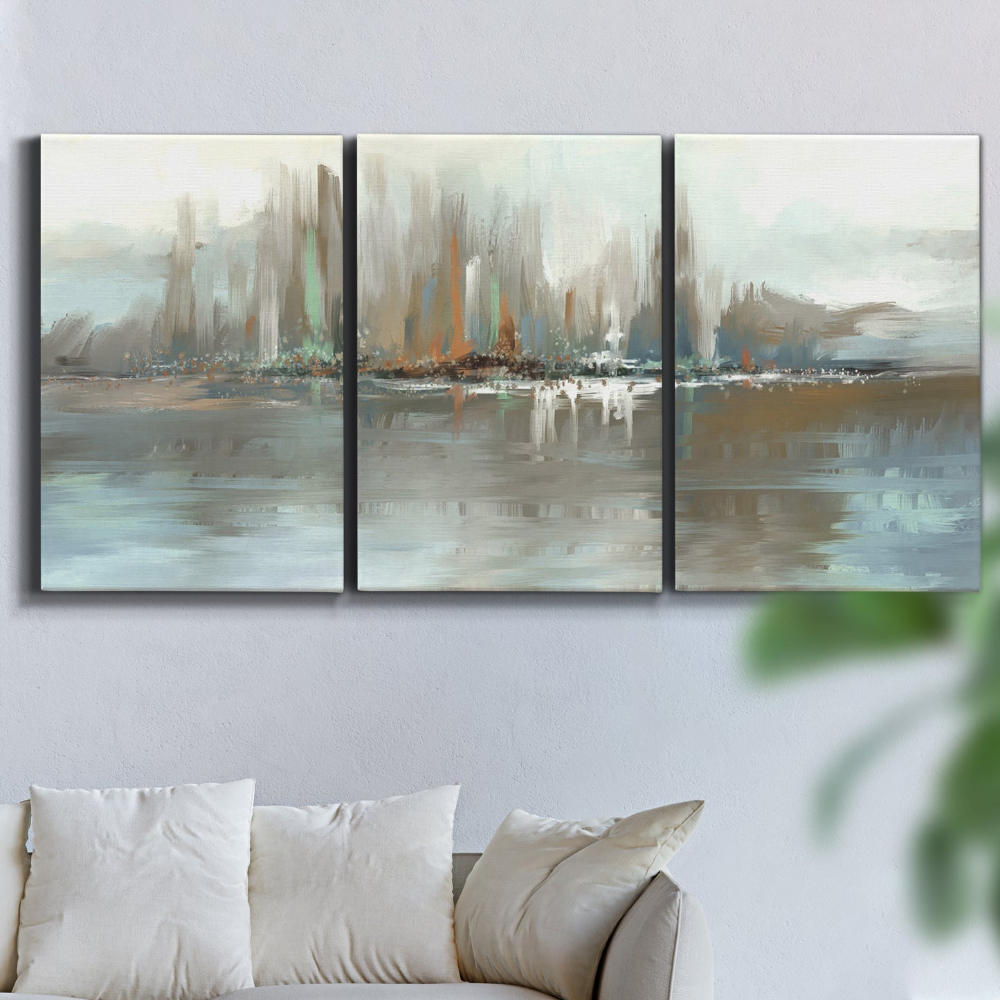 Three-panel canvas wall art featuring glowing abstract city lights, displayed in a living room above a sofa.