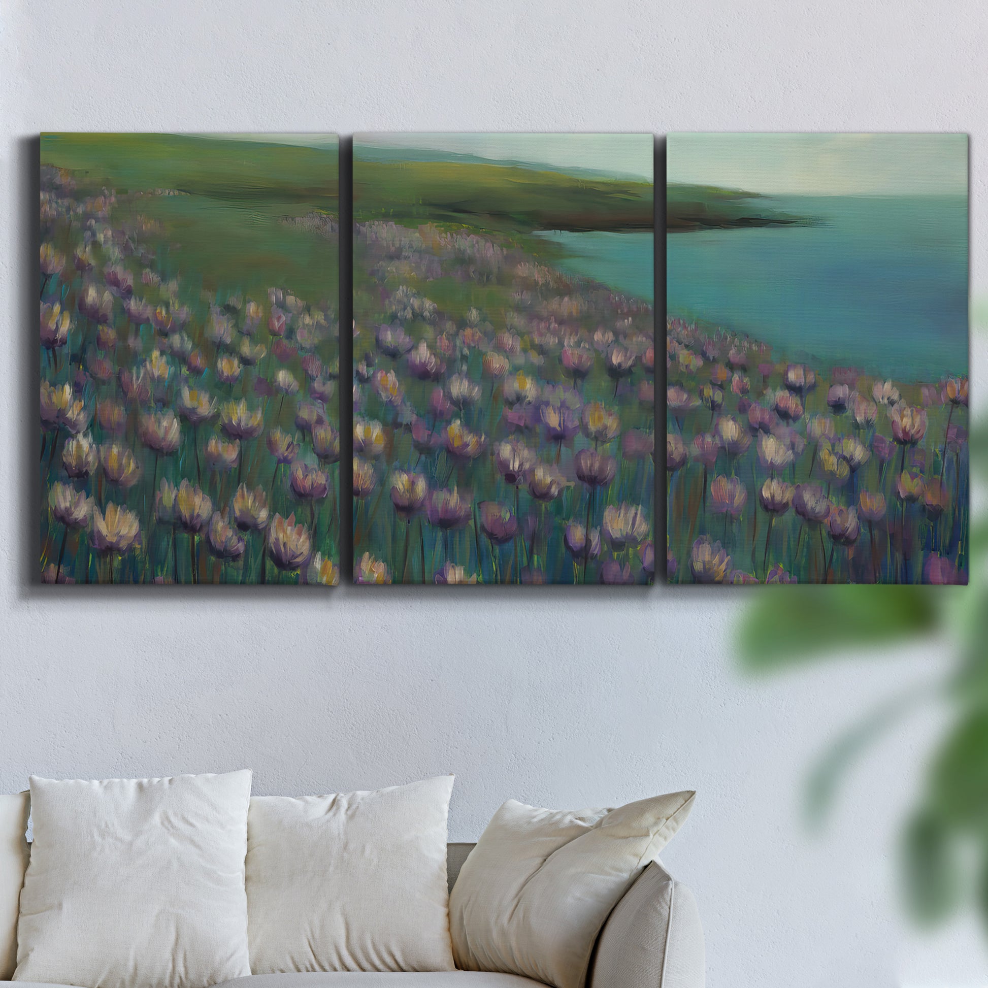 Three-panel canvas wall art featuring calm coastal landscape sanctuary, displayed in a living room above a sofa.