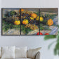 Three-panel canvas wall art featuring still life with pears and grapes, displayed in a living room above a sofa.