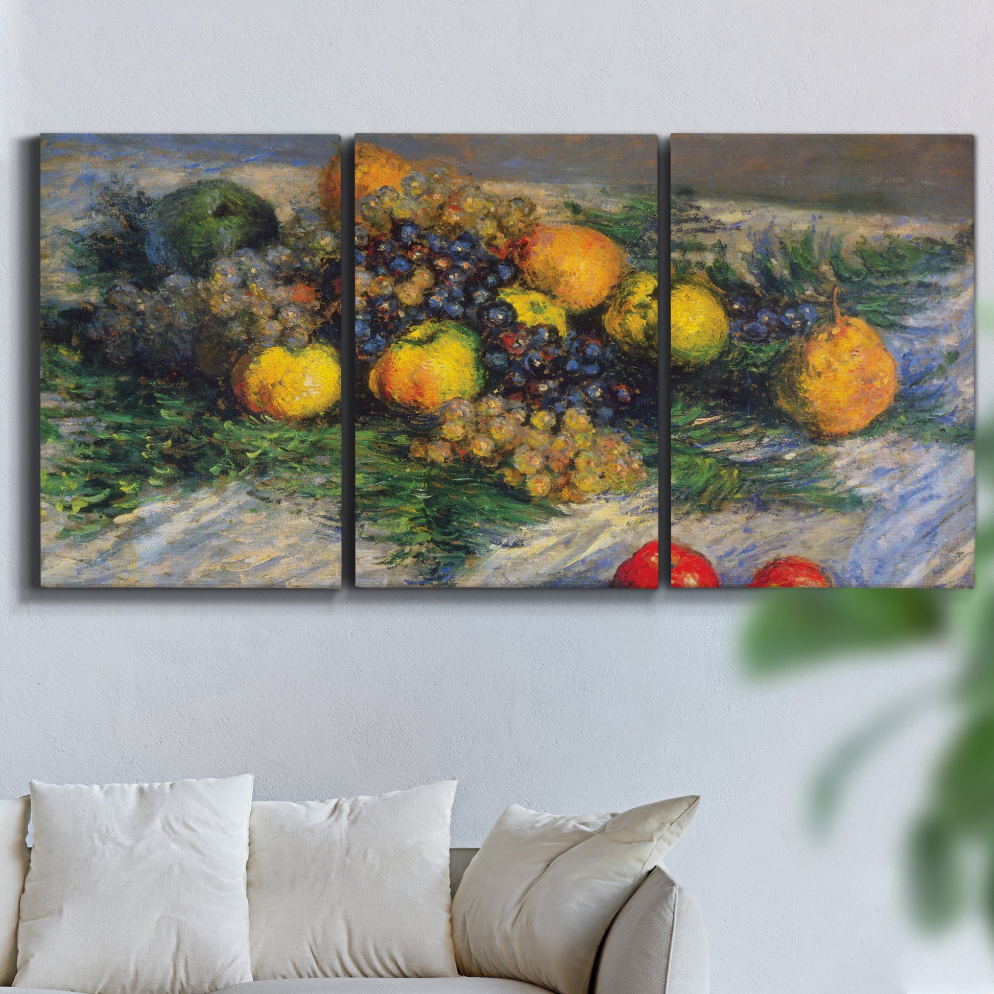 Three-panel canvas wall art featuring still life with pears and grapes, displayed in a living room above a sofa.