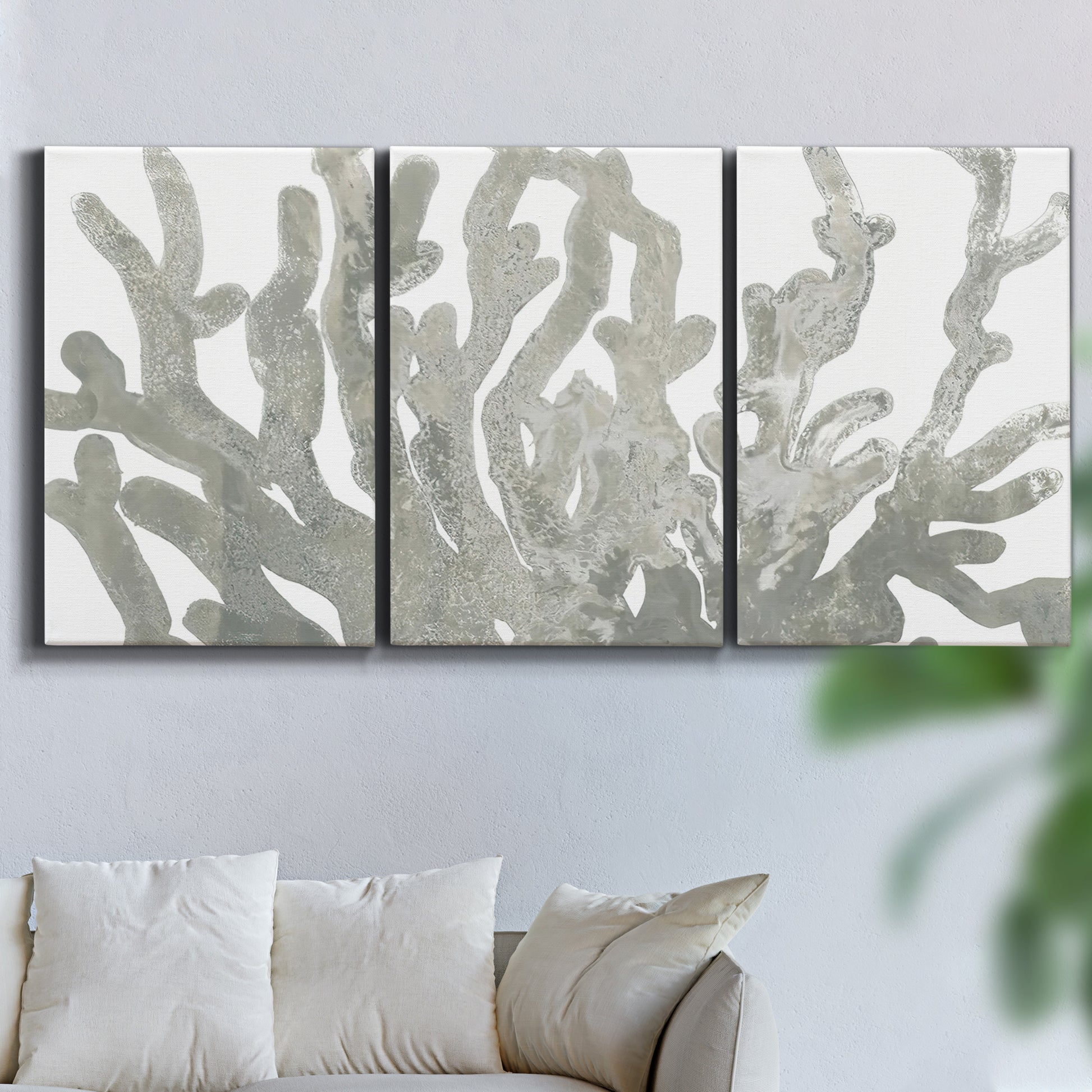 Three-panel canvas wall art featuring monochrome coral texture study, displayed in a living room above a sofa.