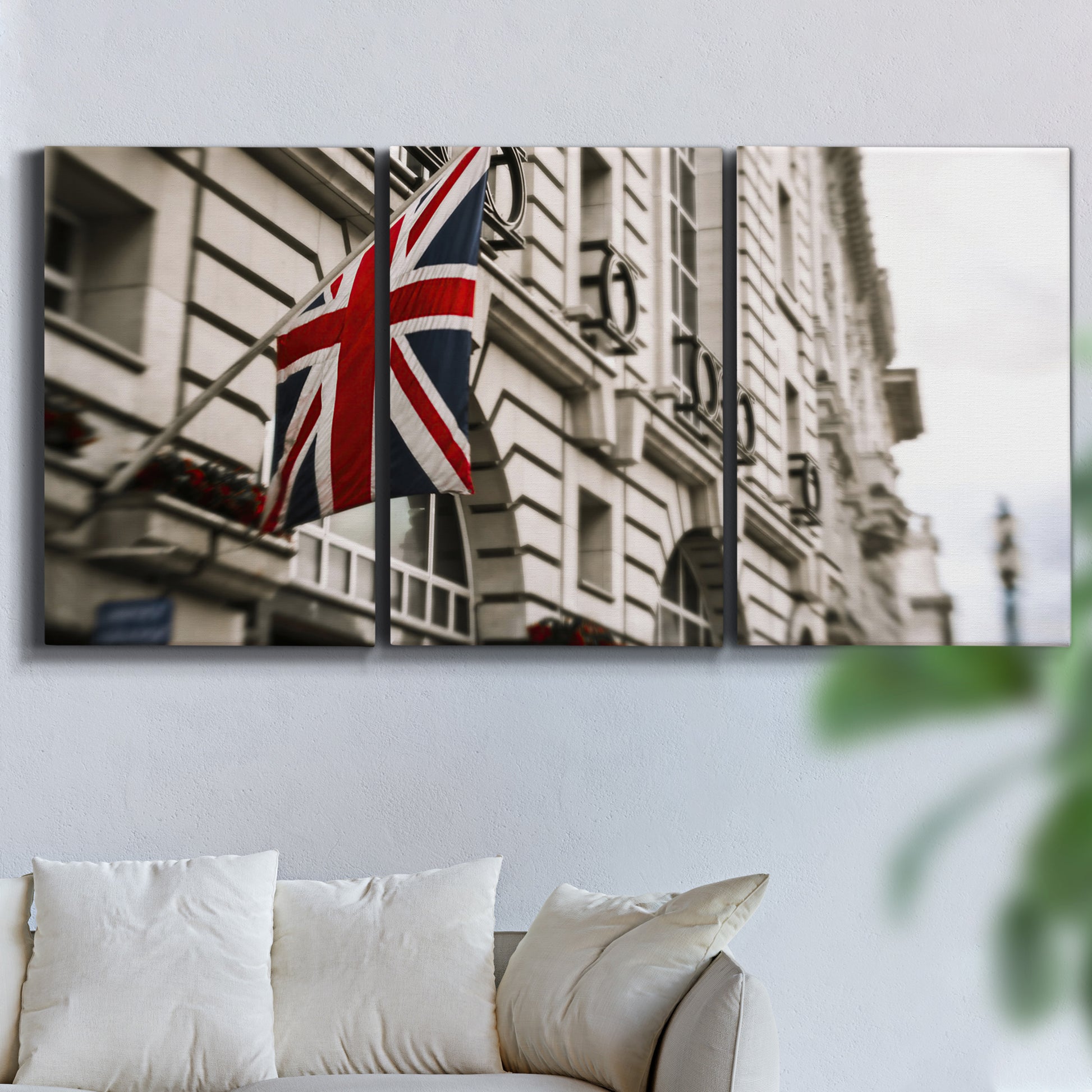 Three-panel canvas wall art featuring london street scene photograph, displayed in a living room above a sofa.