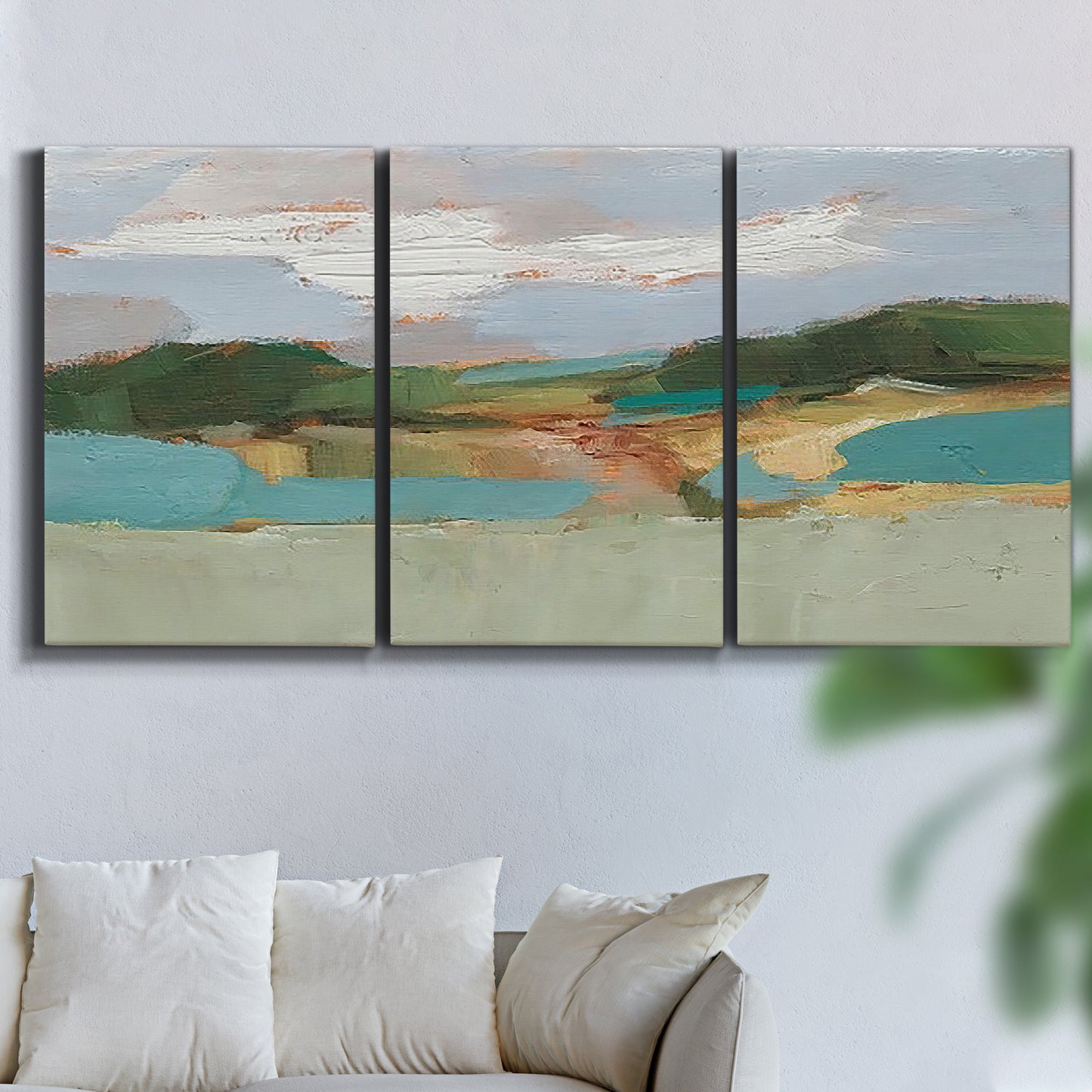 Three-panel canvas wall art featuring wide open landscape under midday light, displayed in a living room above a sofa.