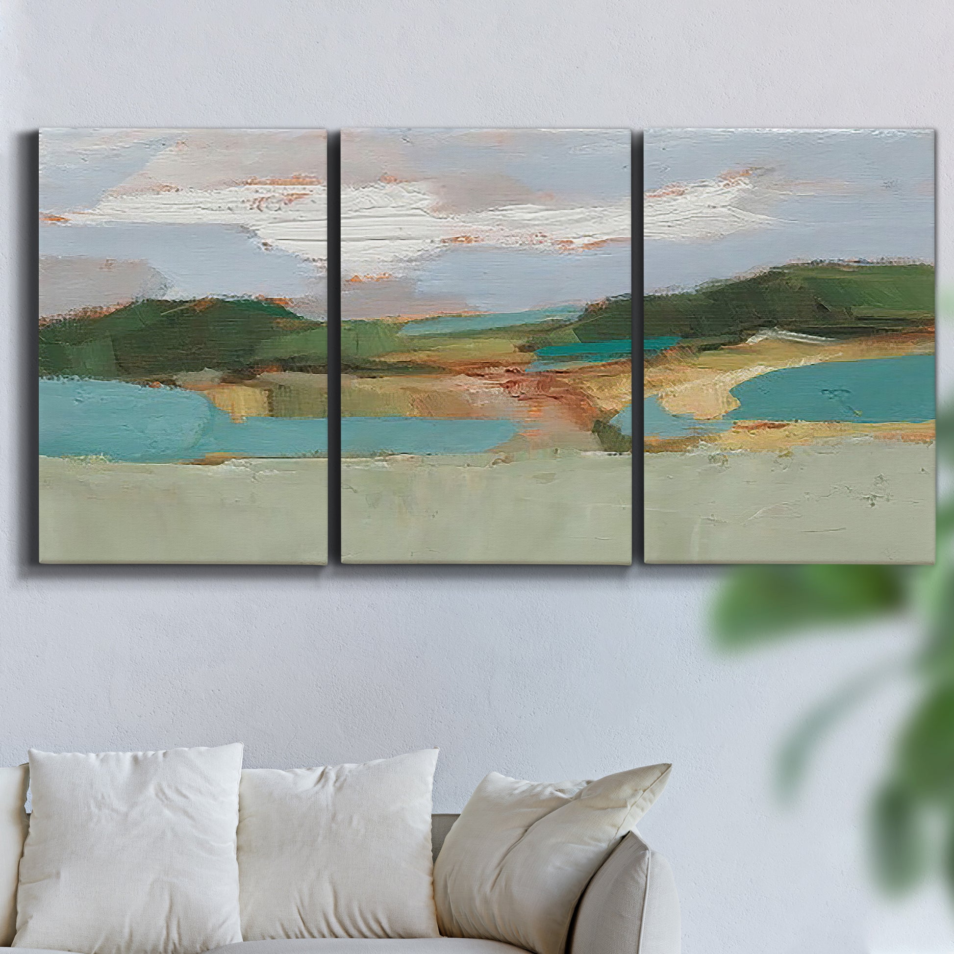 Three-panel canvas wall art featuring wide open landscape under midday light, displayed in a living room above a sofa.