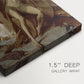 Close-up of a gallery-wrapped canvas corner showing a quiet composition with a resting figure outdoors, highlighting texture and print detail.