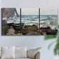 Three-panel canvas wall art featuring rough coastal seas under storm clouds, displayed in a living room above a sofa.