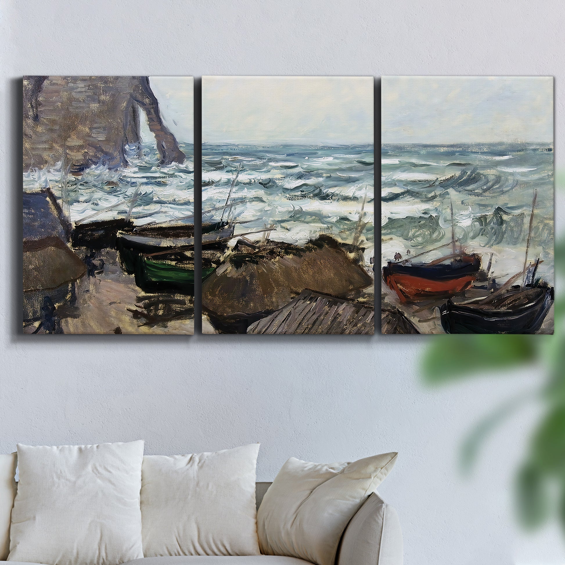 Three-panel canvas wall art featuring rough coastal seas under storm clouds, displayed in a living room above a sofa.