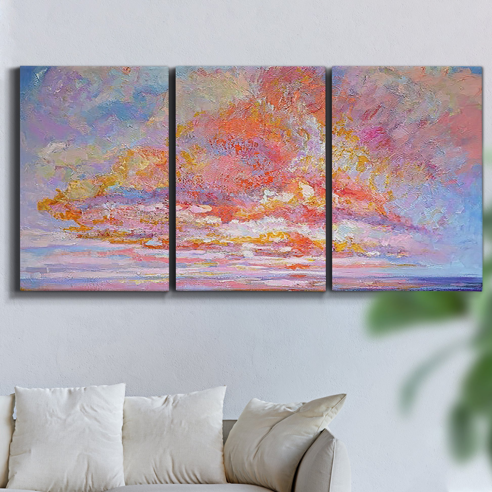 Three-panel canvas wall art featuring peaceful tropical inspired landscape, displayed in a living room above a sofa.